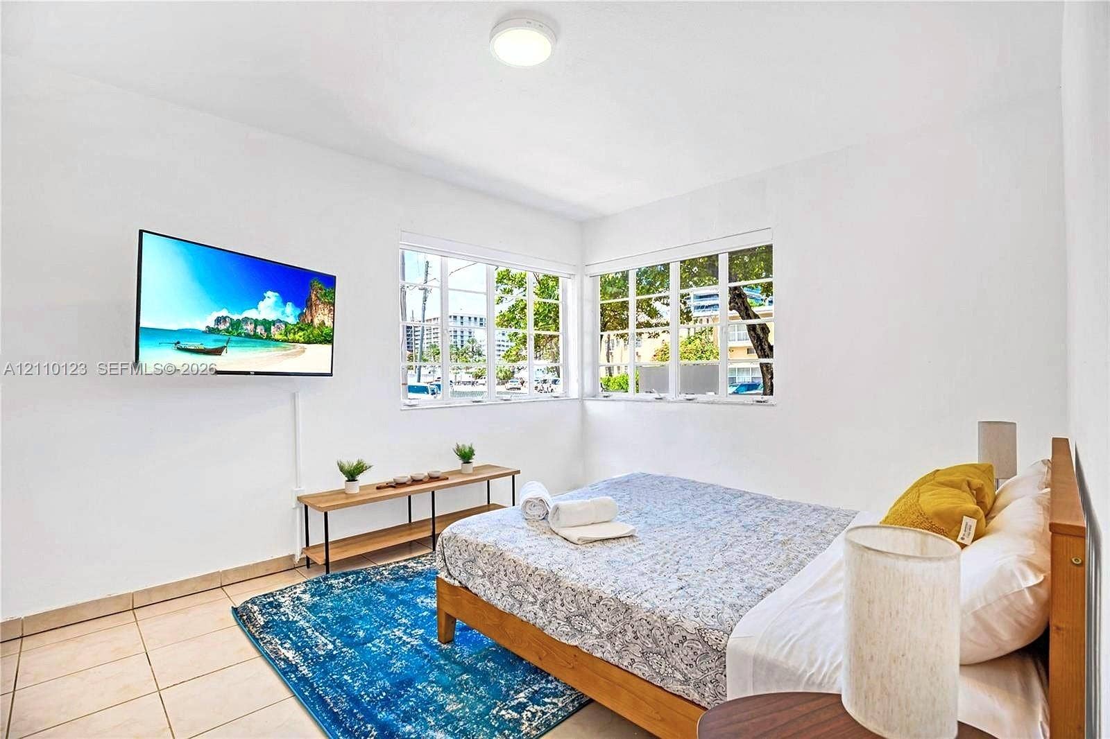 301 86th Street, #303-3, Miami Beach, Miami Beach, FL 33141 Neutral-toned interior featuring ceramic tile flooring, multi-pane windows, and a flush-mount ceiling light fixture