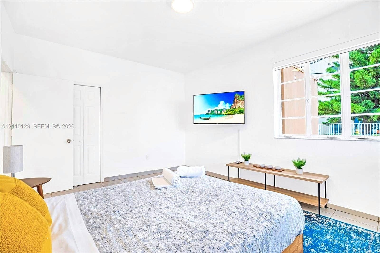 301 86th Street, #303-3, Miami Beach, Miami Beach, FL 33141 Room featuring neutral white walls, large multi-pane window, and smooth-surface tile flooring