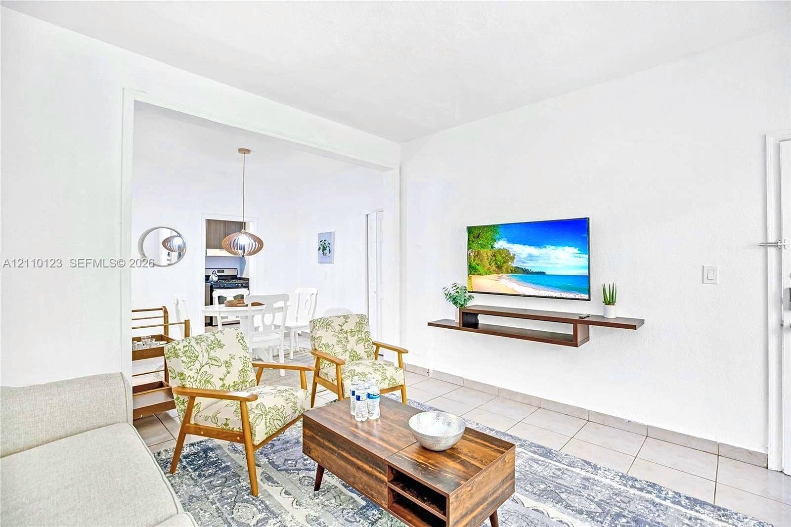 301 86th Street, #303-3, Miami Beach, Miami Beach, FL 33141 Neutral-toned ceramic tile flooring, clean-lined wall-mounted floating media shelf, and recessed ceiling lighting
