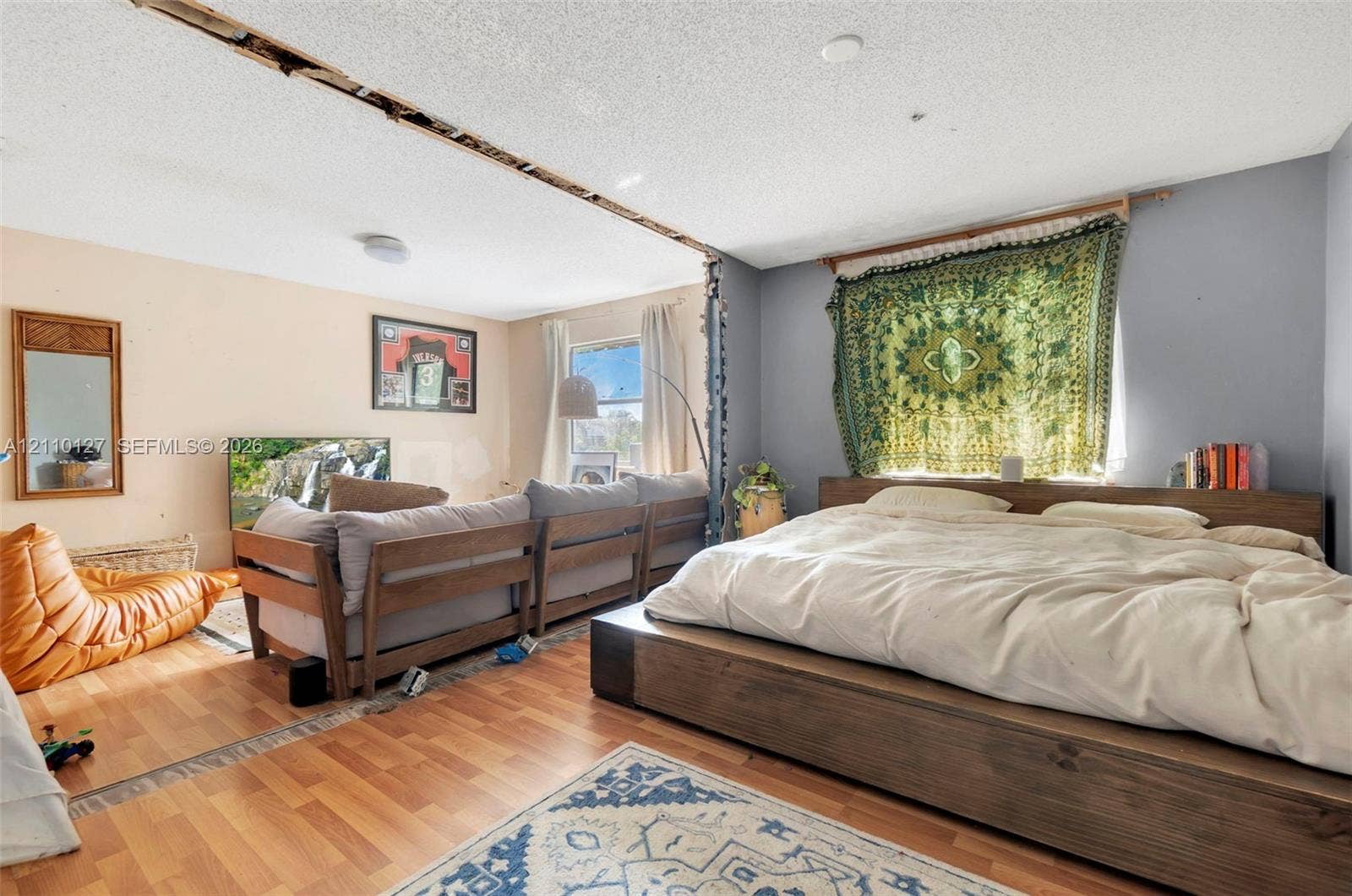 10164 SW 52nd Street, Cooper City, FL 33328 Open-concept interior featuring wood-finish flooring and windows with natural light