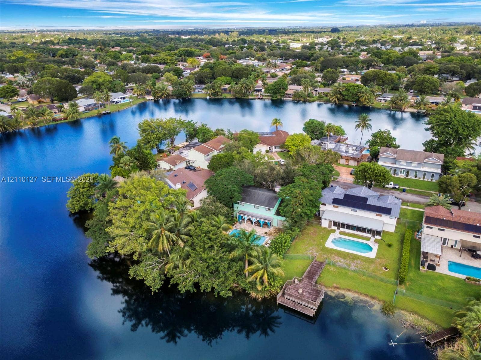 10164 SW 52nd Street, Cooper City, FL 33328 Aerial perspective of waterfront properties featuring deep-water access, private swimming pools, and dedicated dock structures