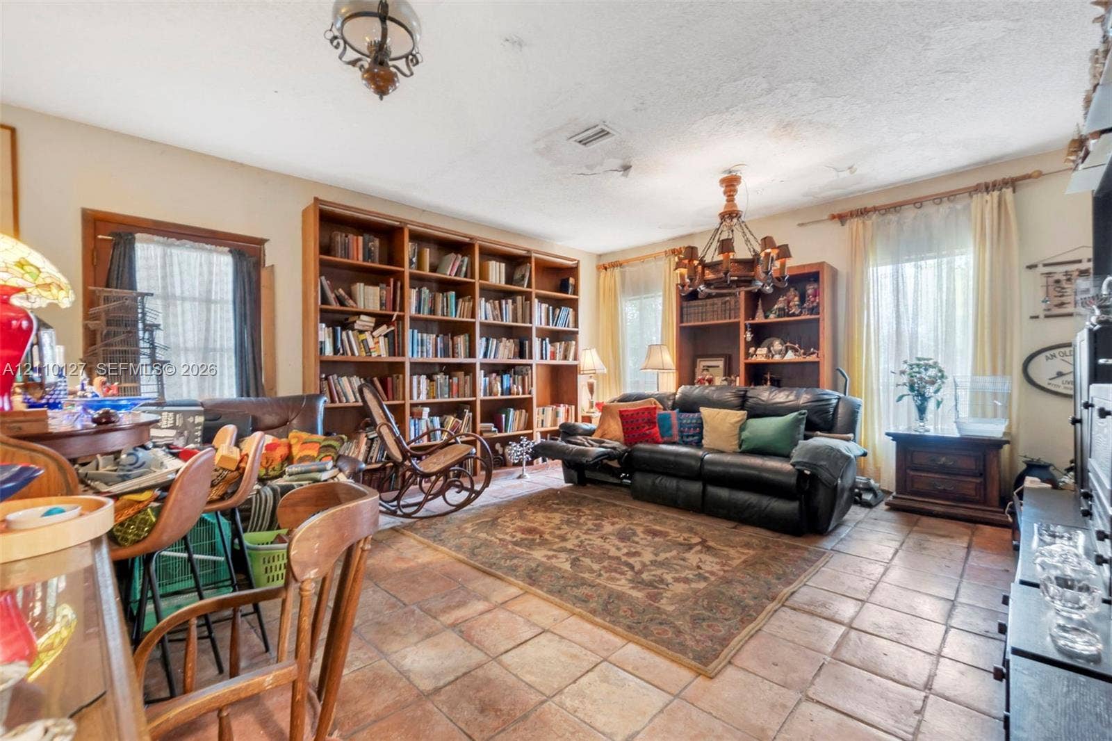 10164 SW 52nd Street, Cooper City, FL 33328 Built-in wall-to-wall wood shelving, ceramic tile flooring, and decorative metal chandelier