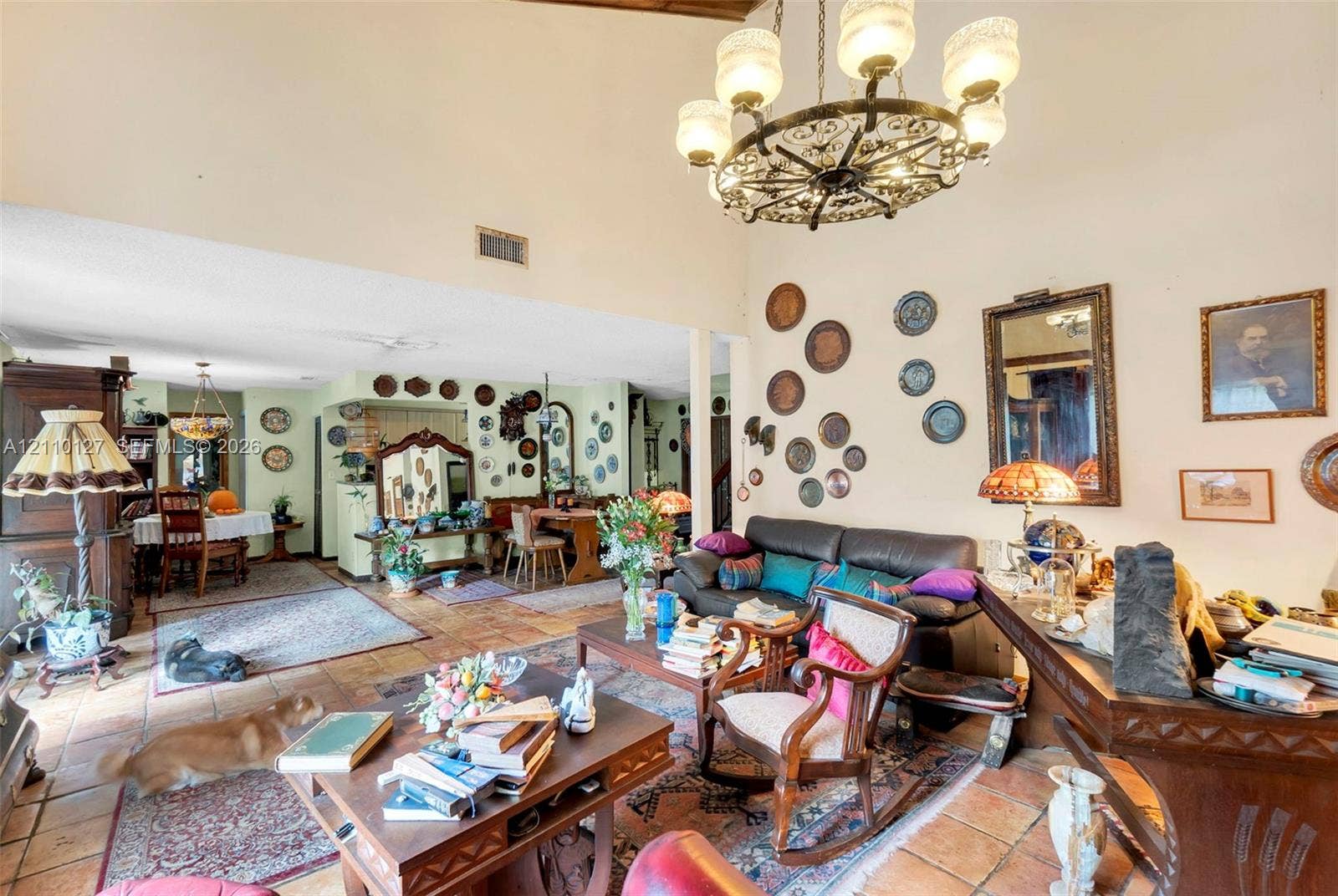 10164 SW 52nd Street, Cooper City, FL 33328 Vaulted ceilings with exposed wood beams, tile flooring, and a decorative wrought-iron chandelier