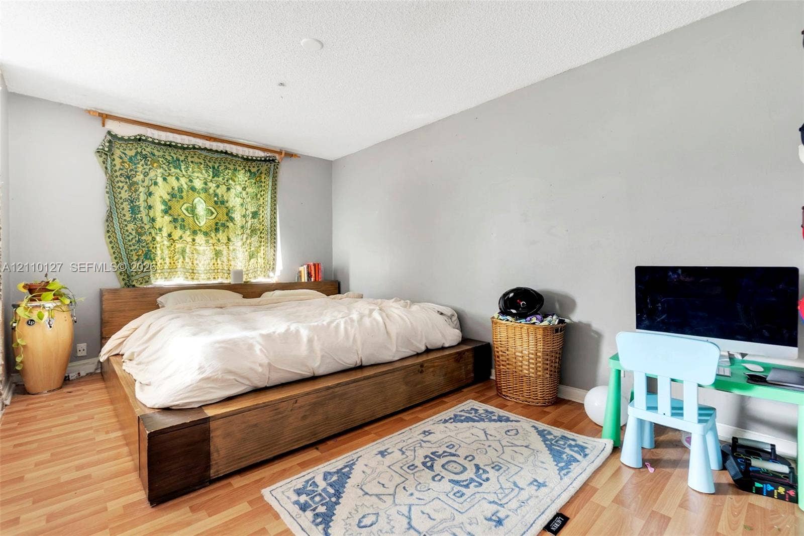 10164 SW 52nd Street, Cooper City, FL 33328 Bedroom interior featuring neutral wall paint, wood-finish flooring, and a window with a mounted curtain rod