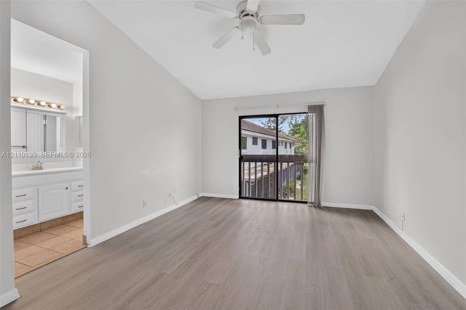 7890 Lago Del Mar Drive, #141, Boca Raton, Boca Raton, FL 33433 Room featuring wood-finish flooring, vaulted ceilings, and a ceiling fan