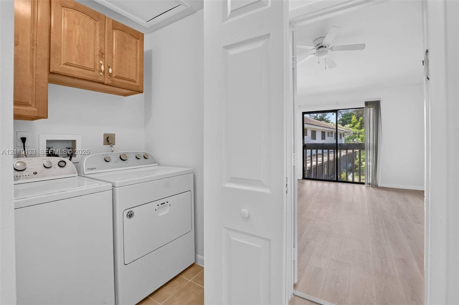 7890 Lago Del Mar Drive, #141, Boca Raton, Boca Raton, FL 33433 Laundry area featuring upper wood-finish cabinetry, tile flooring, and white washer and dryer units