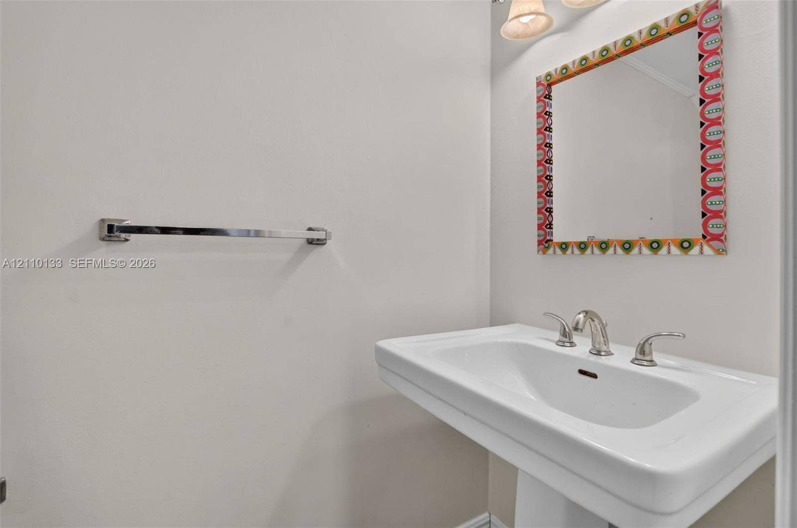 7890 Lago Del Mar Drive, #141, Boca Raton, Boca Raton, FL 33433 Wall-mounted pedestal sink featuring a widespread polished chrome faucet, polished chrome towel bar, and multi-light vanity fixture