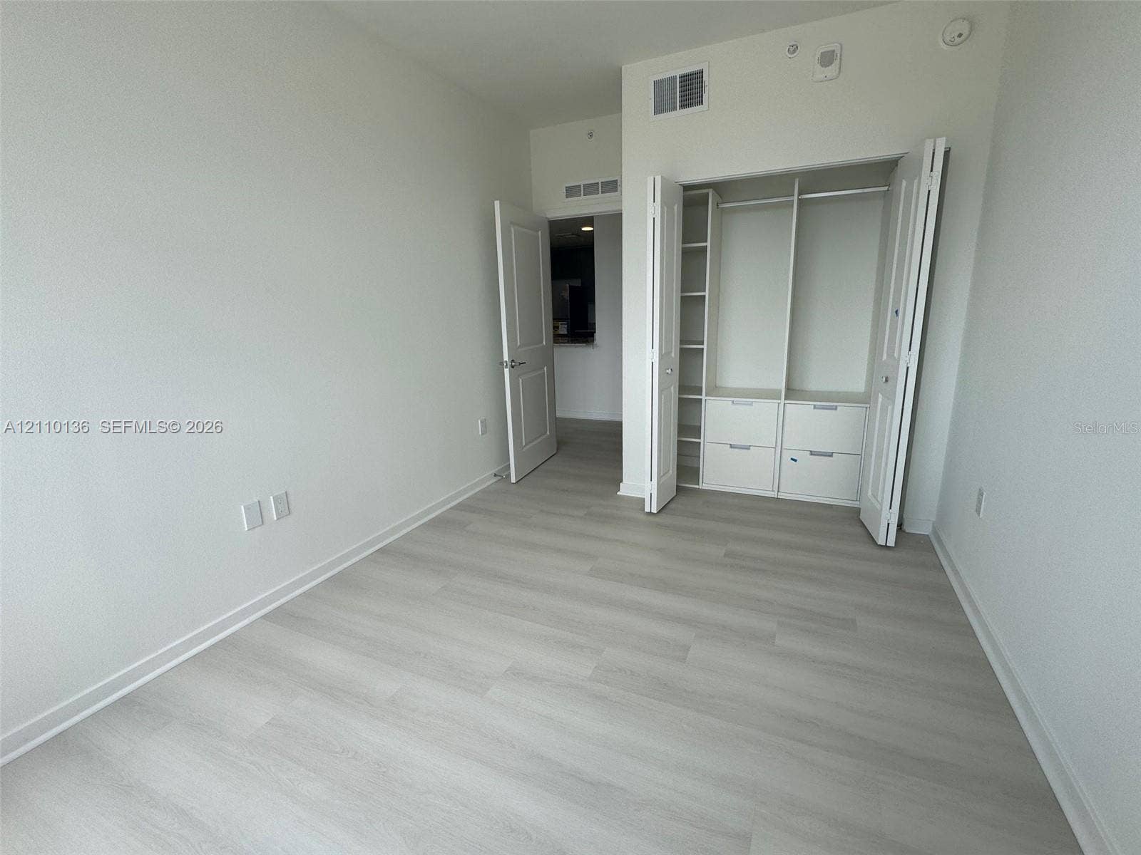 5563 Millenia Park Boulevard, #328, Orlando, Orlando, FL 32839 Wood-finish flooring, interior closet with custom built-in shelving and drawers, and paneled swinging door