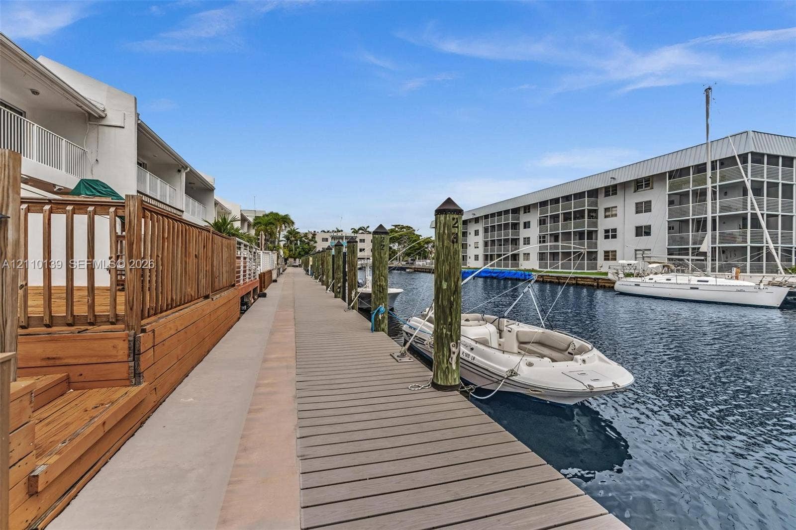 3601 NE 168th Street, #108, North Miami Beach, FL 33160 Waterfront composite dock featuring wooden pilings and bulkhead-level access to a deep-water canal