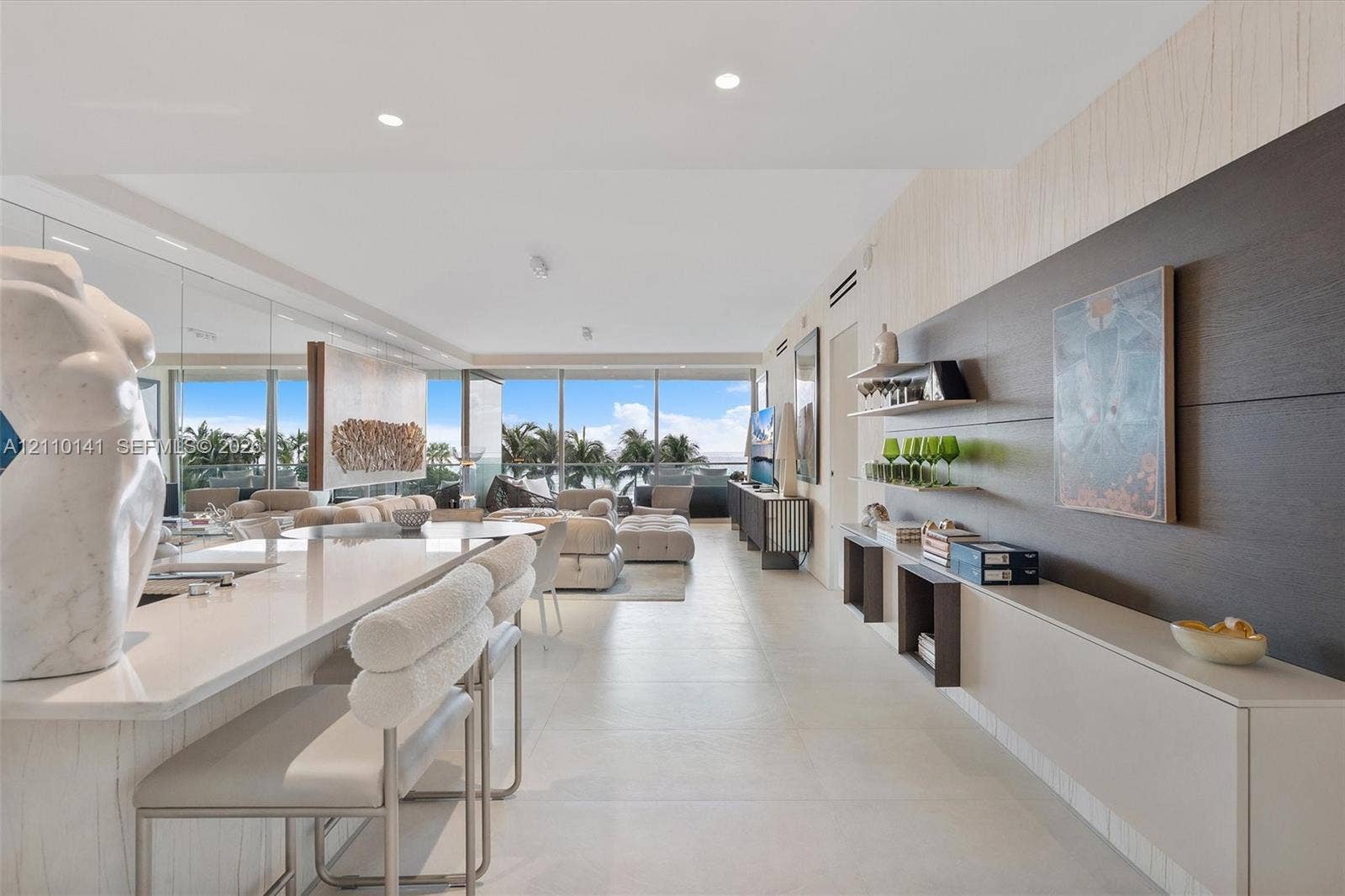 10203 Collins Avenue, #303, Bal Harbour, FL 33154 custom wall-mounted cabinetry, and a stone-surface waterfall edge island, kitchen was remodeled
