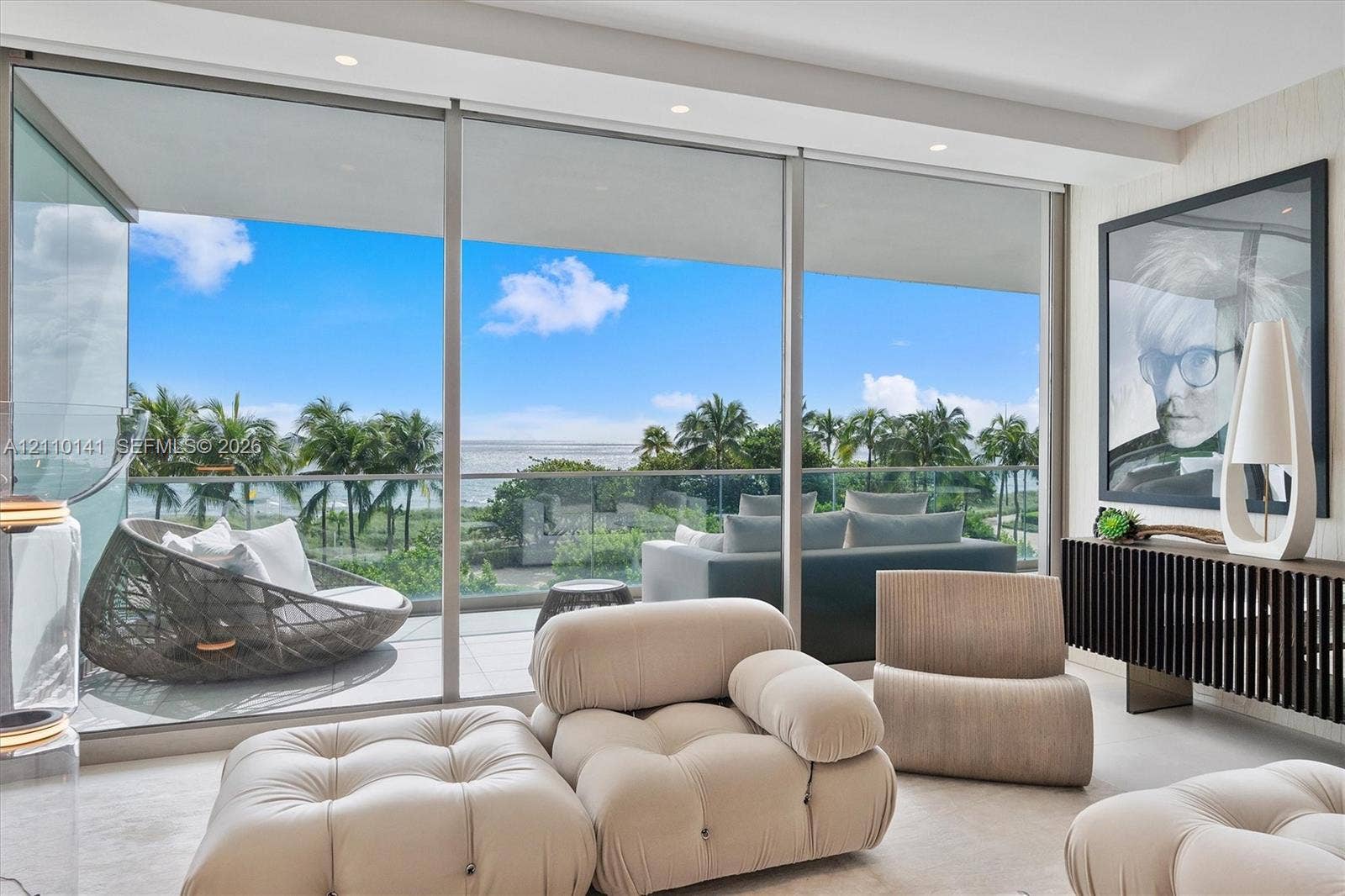 10203 Collins Avenue, #303, Bal Harbour, FL 33154 Floor-to-ceiling sliding glass walls, recessed ceiling lighting, and a private balcony with glass railingcorner unit overlooking direct ocean views