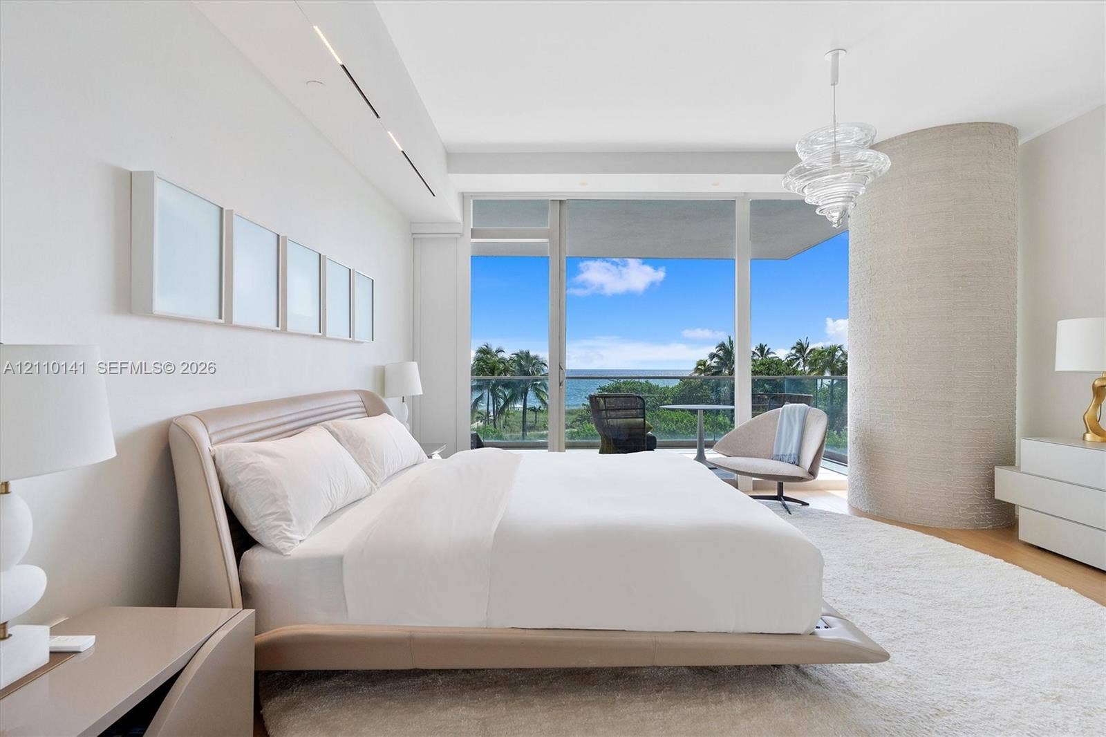10203 Collins Avenue, #303, Bal Harbour, FL 33154 Master bedroom ,Floor-to-ceiling glass doors, private balcony, wood-finish flooring , Exquisite contemporary furnishings