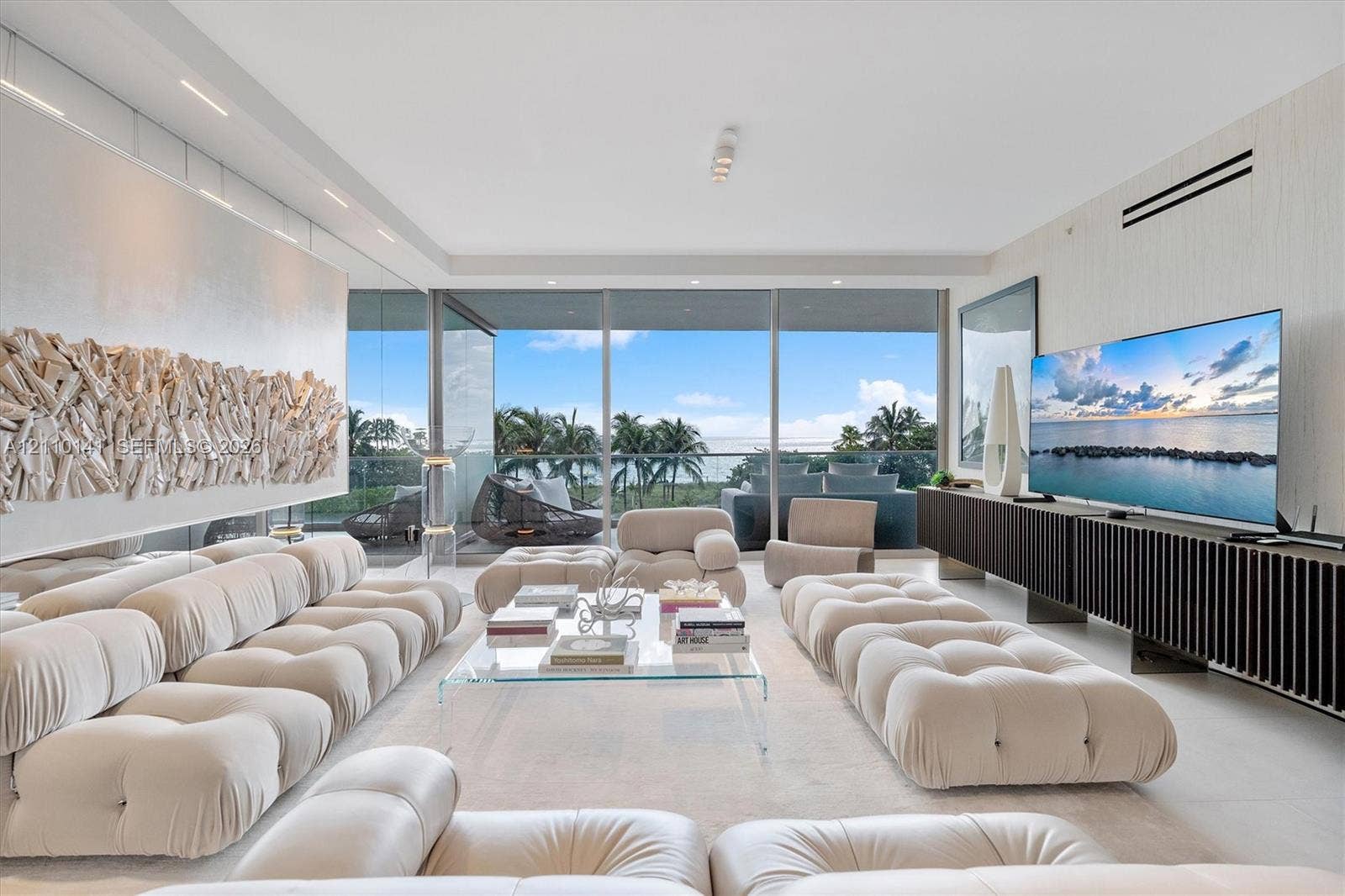 10203 Collins Avenue, #303, Bal Harbour, FL 33154 Living space featuring floor-to-ceiling glass sliding doors, wood-slatted built-in media cabinetry, recessed ceiling lighting, and large-formal living