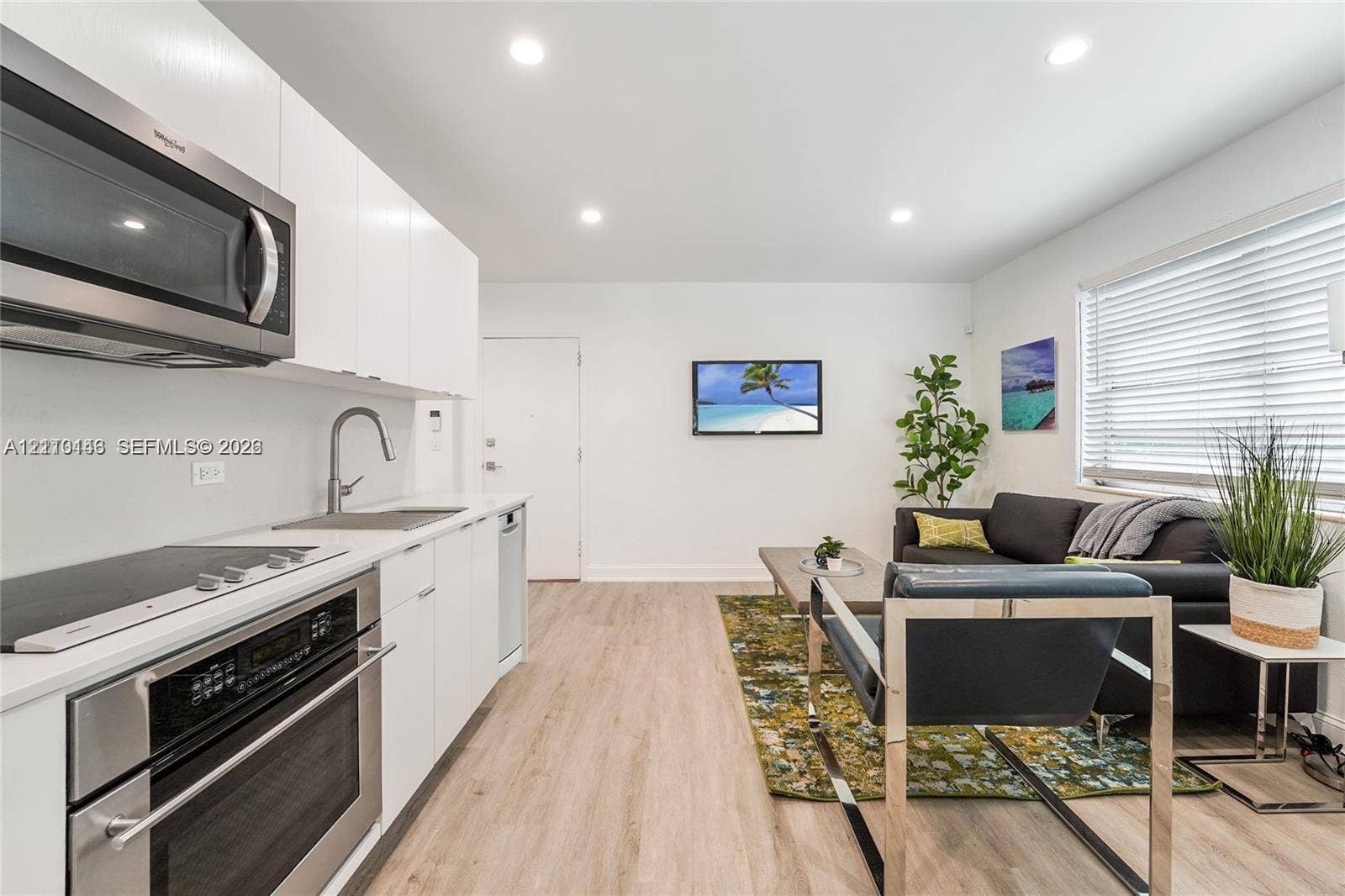 1407 Meridian Avenue, #7, Miami Beach, Miami Beach, FL 33139 Kitchen featuring white flat-panel cabinetry, stainless steel appliances, recessed lighting, and wood-finish flooring