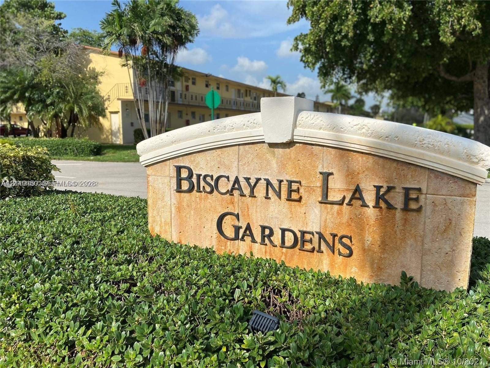 20111 NE 27th Court, #K212, Aventura, Aventura, FL 33180 Stone-clad community monument sign featuring dimensional metal lettering and manicured landscape hedging