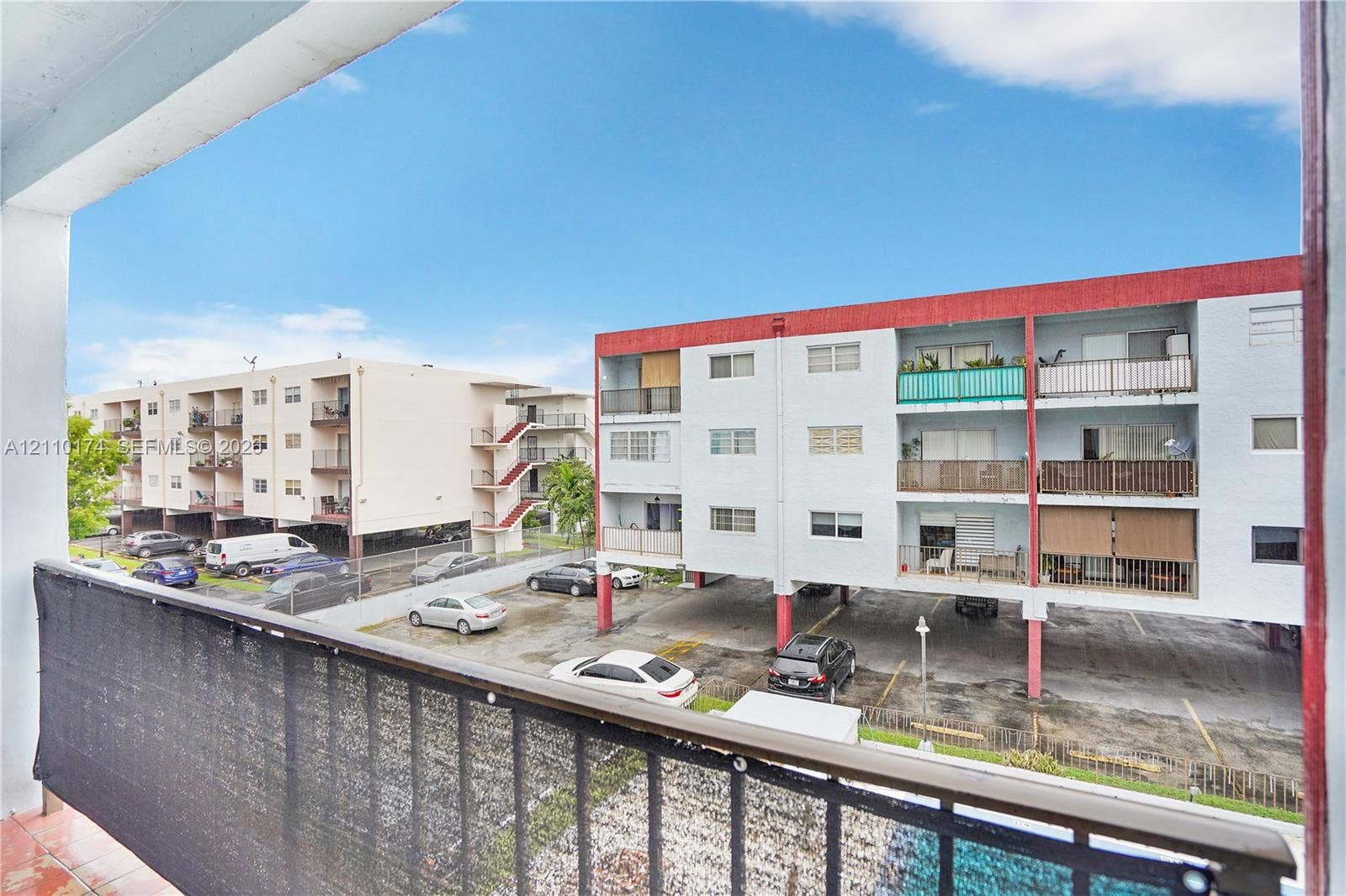 Private balcony featuring metal railings and paved flooring