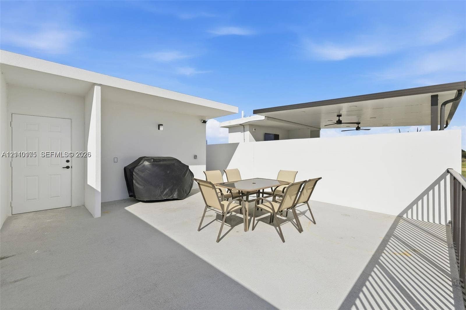 26122 SW 145th Court, #26122, Homestead, Homestead, FL 33032 Outdoor terrace featuring concrete flooring, a covered patio area with dual ceiling fans, and a privacy wall