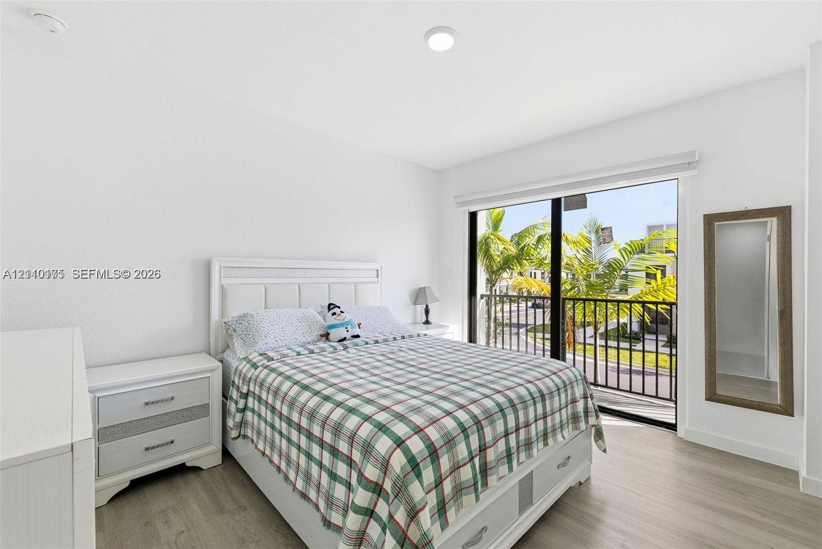 26122 SW 145th Court, #26122, Homestead, Homestead, FL 33032 Bedroom featuring wood-finish flooring, recessed lighting, and a sliding glass door providing access to a balcony with metal railings