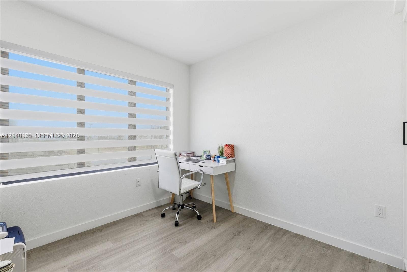26122 SW 145th Court, #26122, Homestead, Homestead, FL 33032 Interior room featuring wood-finish flooring, smooth white walls, and horizontal dual-layer light-filtering window shades