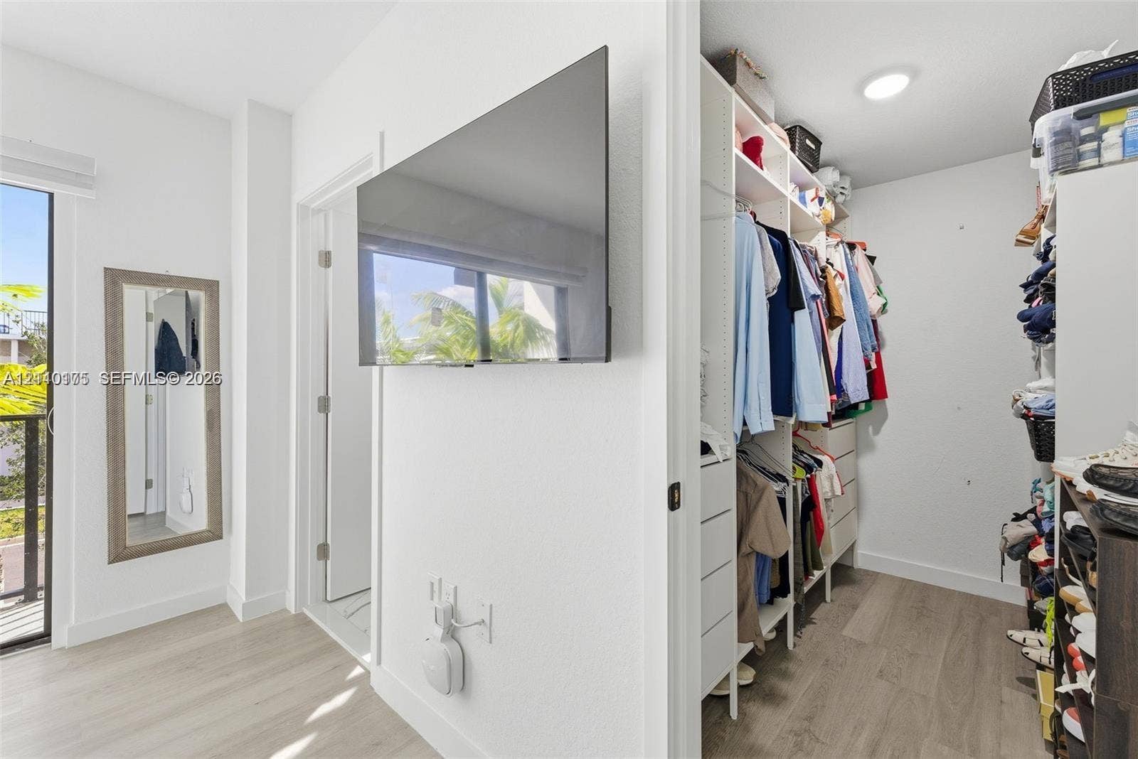 26122 SW 145th Court, #26122, Homestead, Homestead, FL 33032 Walk-in closet featuring built-in shelving and drawer storage, wood-finish flooring, recessed lighting, and a glass-paned door