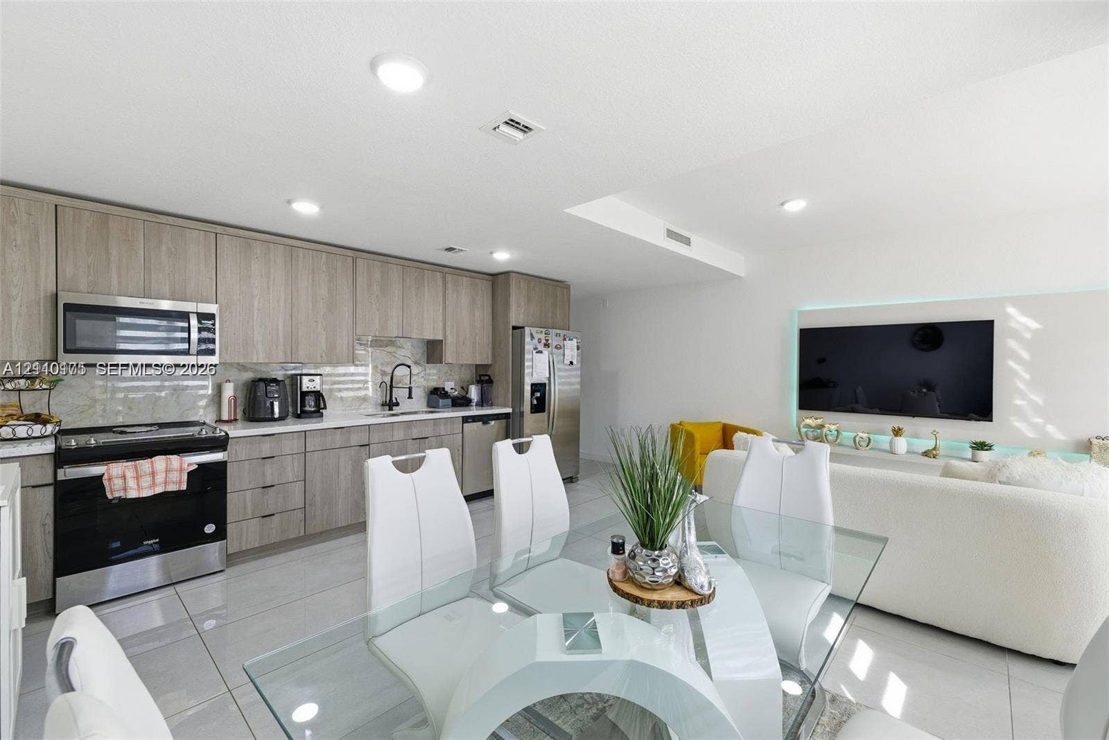 26122 SW 145th Court, #26122, Homestead, Homestead, FL 33032 Kitchen featuring wood-finish flat-panel cabinetry, stone countertops, stainless steel appliances, recessed ceiling lighting, and porcelain tile flooring