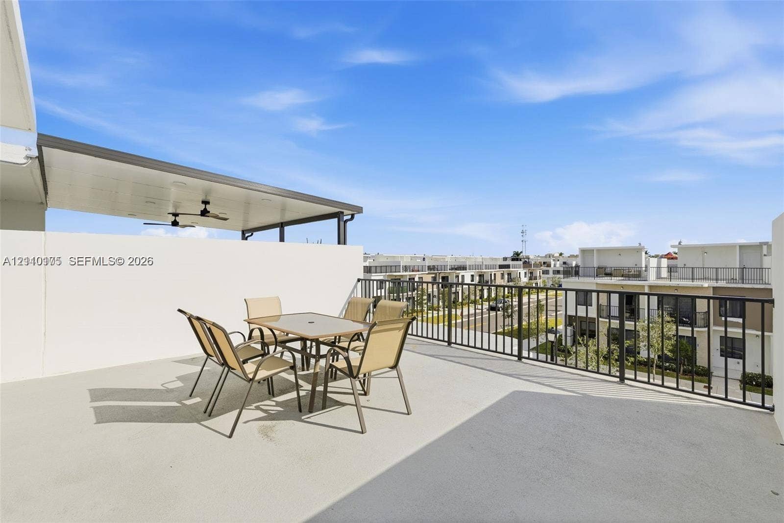 26122 SW 145th Court, #26122, Homestead, Homestead, FL 33032 Expansive rooftop terrace featuring a covered patio area, ceiling fans, concrete flooring, and perimeter metal railings