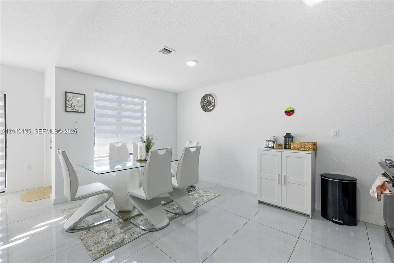 26122 SW 145th Court, #26122, Homestead, Homestead, FL 33032 Open-concept dining area featuring large-format tile flooring, recessed lighting, and dual-layered window shades