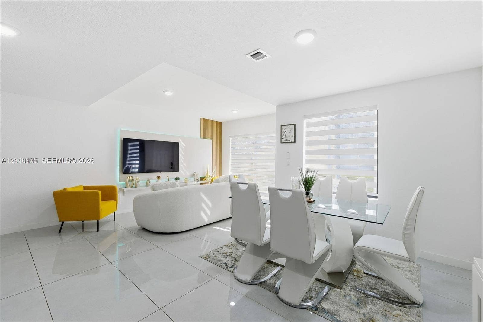 26122 SW 145th Court, #26122, Homestead, Homestead, FL 33032 Large-format tile flooring, recessed ceiling lighting, and a custom media wall with integrated accent lighting