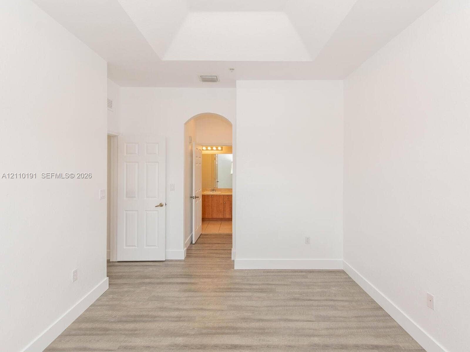 8999 NW 107 Court, #218-1, Miami, Miami, FL 33178 Tray ceiling, wood-finish flooring, and arched architectural detail
