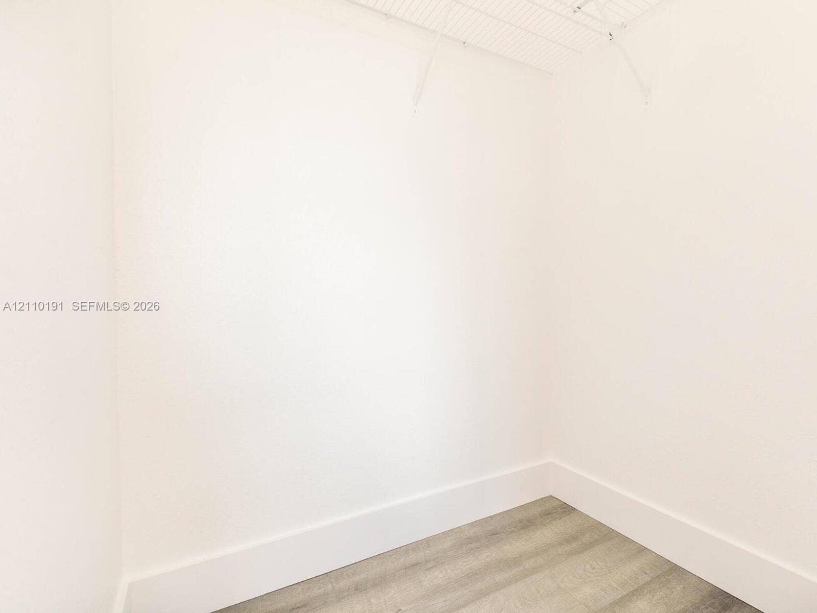 8999 NW 107 Court, #218-1, Miami, Miami, FL 33178 Walk-in closet featuring neutral walls, wood-finish flooring, and white wire shelving