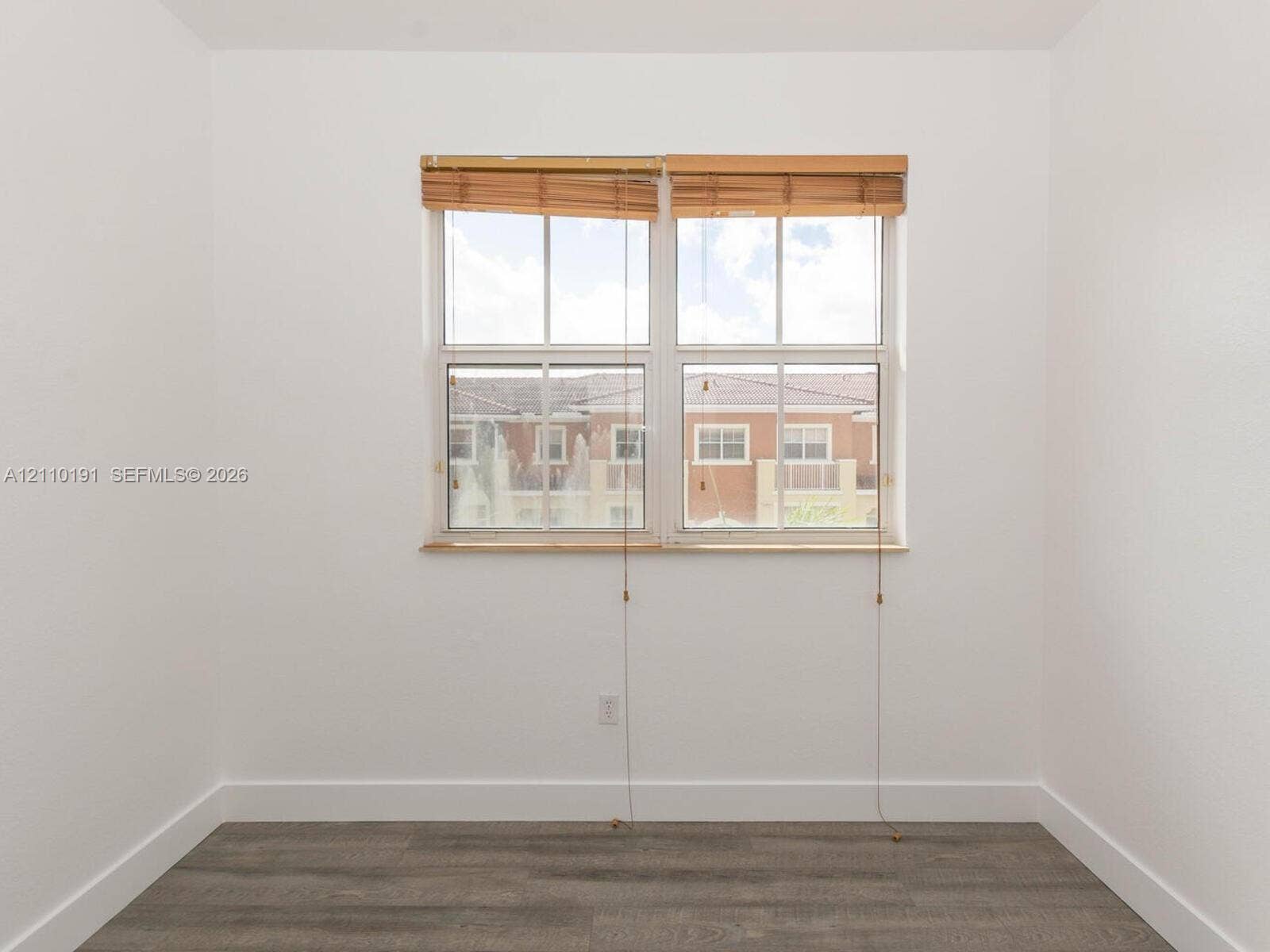 8999 NW 107 Court, #218-1, Miami, Miami, FL 33178 Neutral wall tones paired with gray wood-finish flooring and double-hung window featuring built-in wood-slat blinds