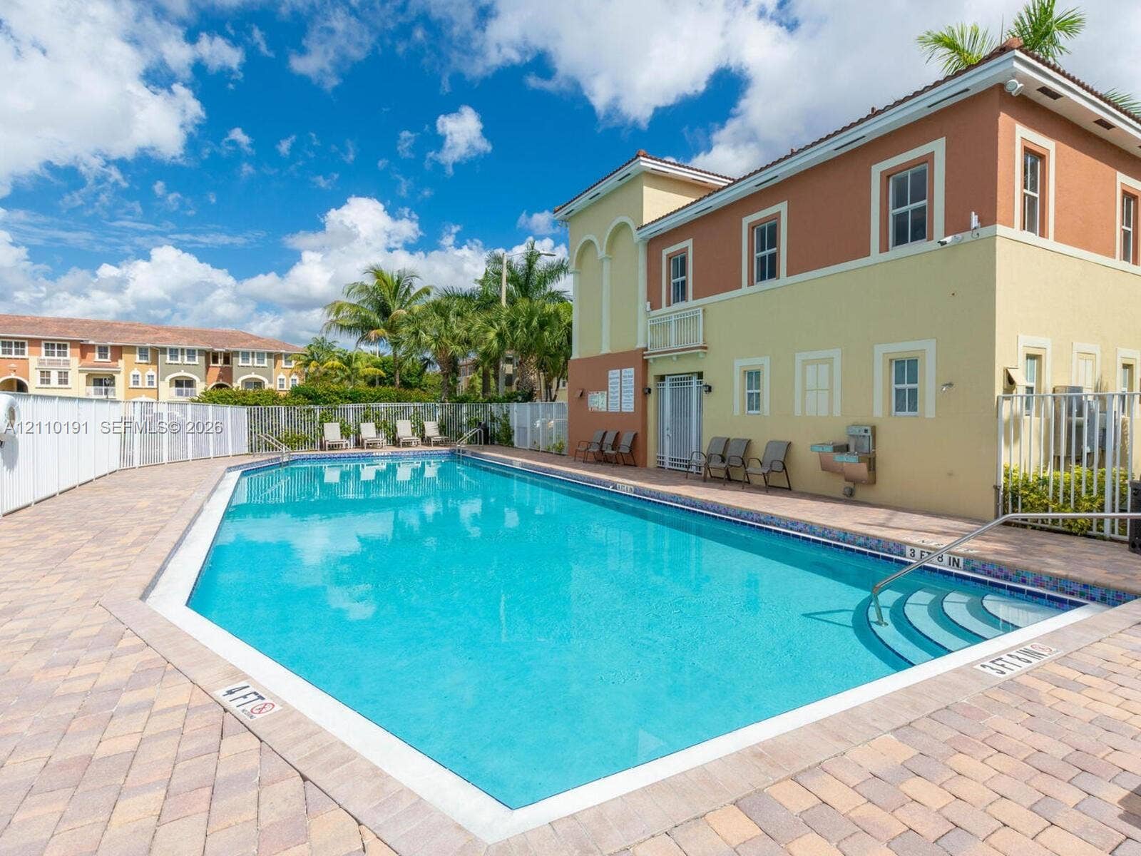 8999 NW 107 Court, #218-1, Miami, Miami, FL 33178 Swimming pool featuring integrated stair entry, light-toned masonry pavers, and perimeter metal fencing