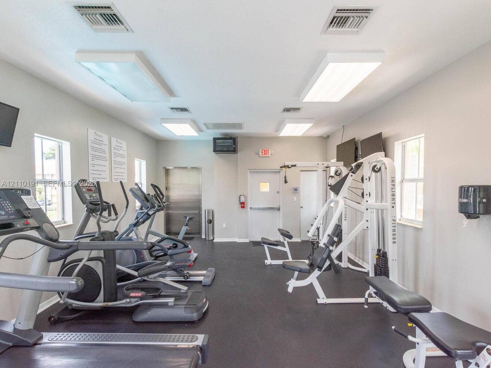 8999 NW 107 Court, #218-1, Miami, Miami, FL 33178 Fitness room featuring durable rubber flooring, multiple dual-pane windows, and high-output overhead lighting
