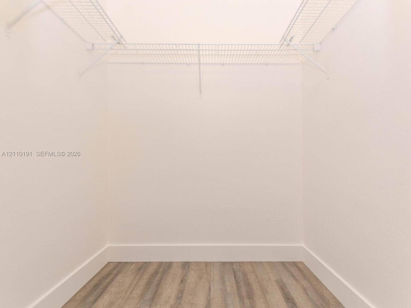 8999 NW 107 Court, #218-1, Miami, Miami, FL 33178 Walk-in closet featuring white wire shelving and wood-finish flooring