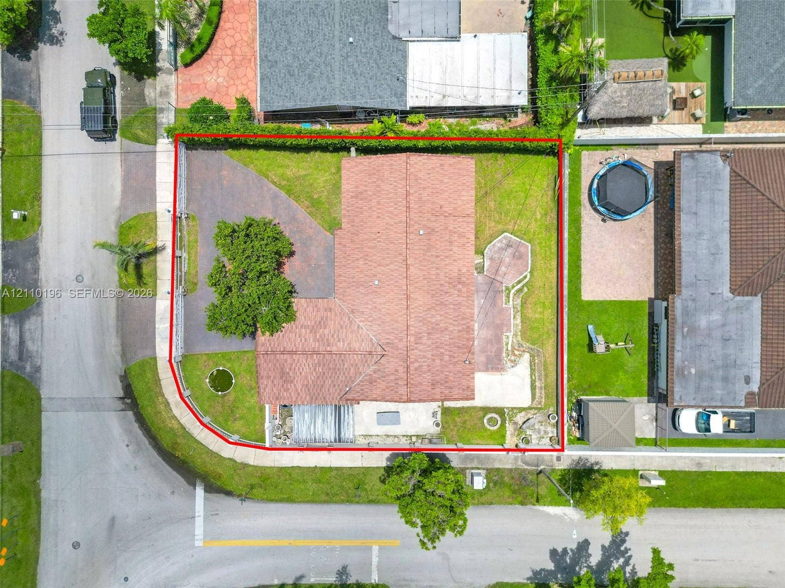 4400 SW 89th Avenue, #4400, Miami, Miami, FL 33165 Corner lot featuring a multi-faceted roofline, paved driveway, concrete patio, and fenced perimeter