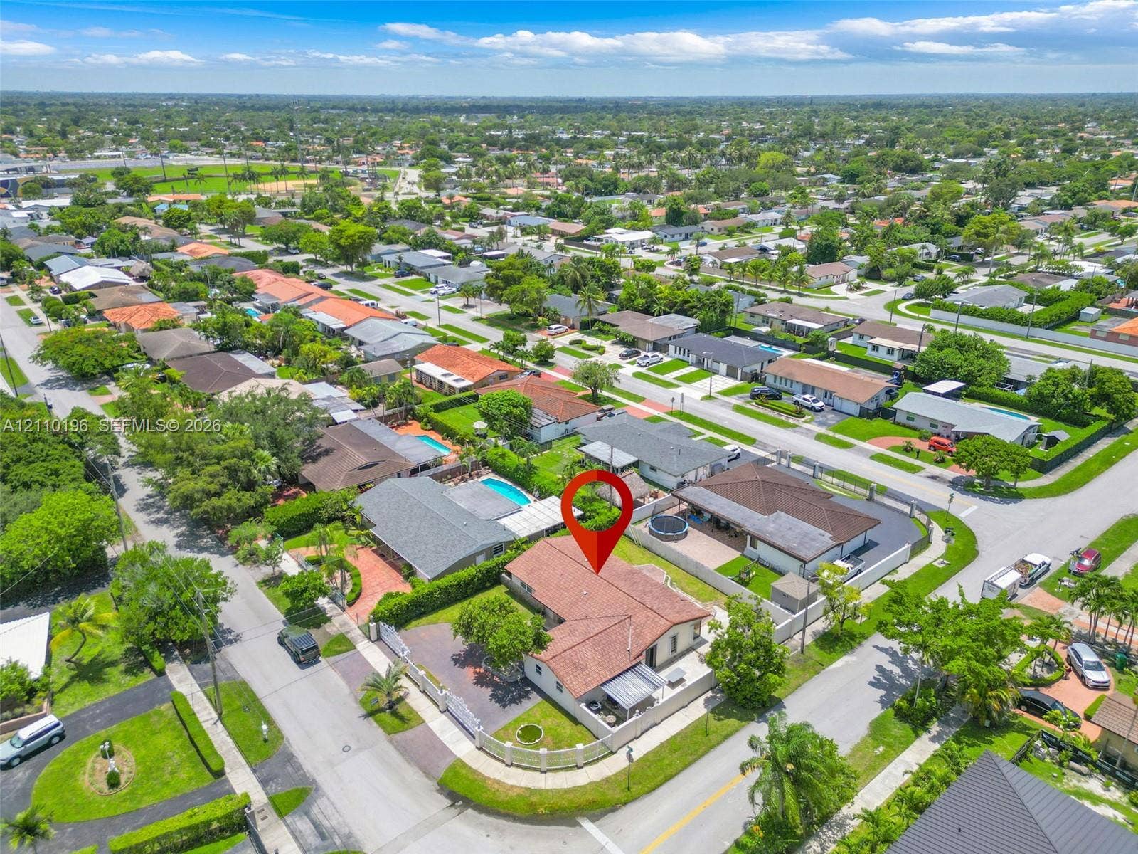 4400 SW 89th Avenue, #4400, Miami, Miami, FL 33165 Aerial perspective of a residence featuring a clay tile roof, concrete perimeter wall, paved driveway, and mature landscaping