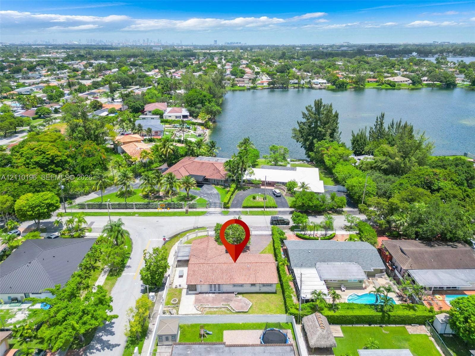 4400 SW 89th Avenue, #4400, Miami, Miami, FL 33165 Aerial perspective of a single-story residence featuring a shingled roof, a paved rear patio, and a manicured lawn