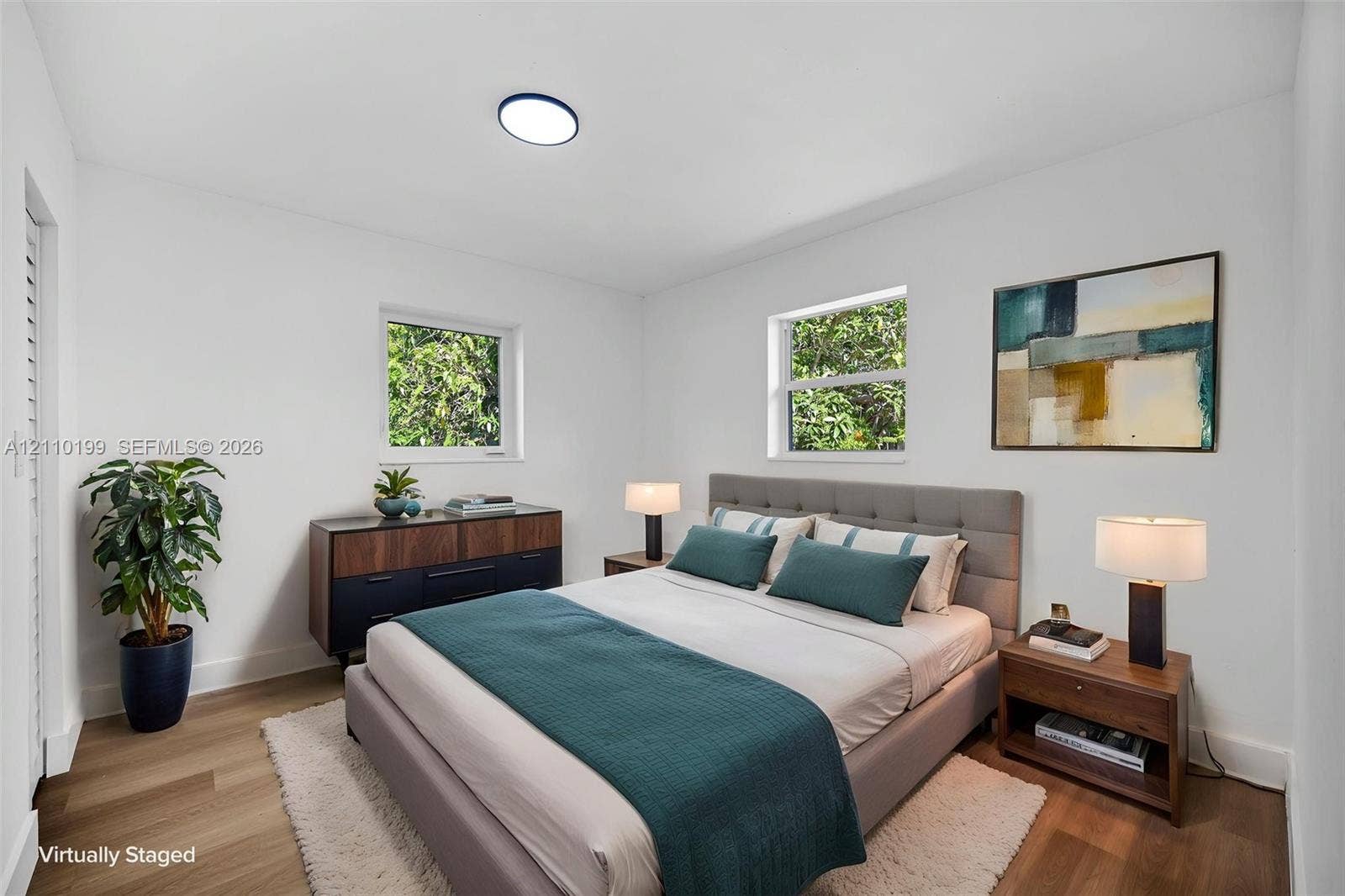 10741 SW 165th Street, Miami, FL 33157 Neutral interior featuring wood-finish flooring, two dual-pane windows, and a flush-mount ceiling light fixture
