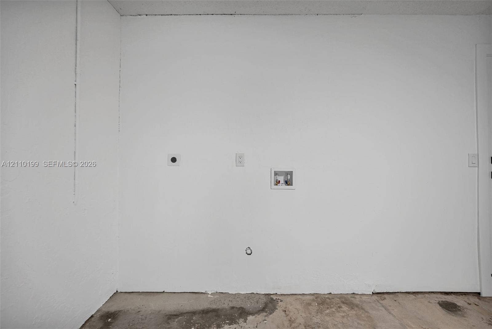 10741 SW 165th Street, Miami, FL 33157 Dedicated utility area featuring washer and dryer hookups, recessed plumbing supply box, and electrical outlet