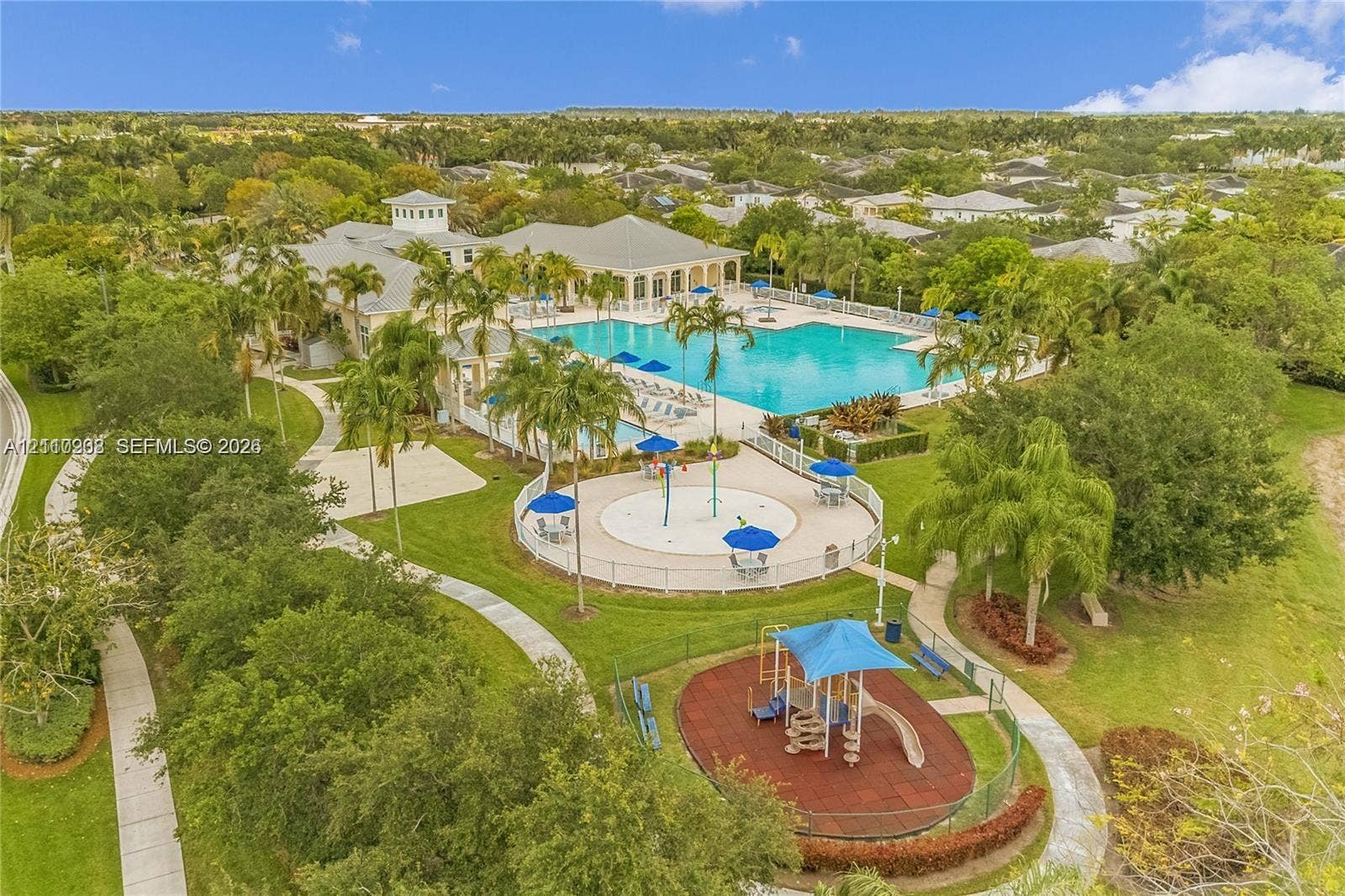 657 SE 30th Terrace, #A, Homestead, Homestead, FL 33033 Recreational complex featuring a large swimming pool, splash pad, paved pathways, and an outdoor play area situated within a landscaped setting