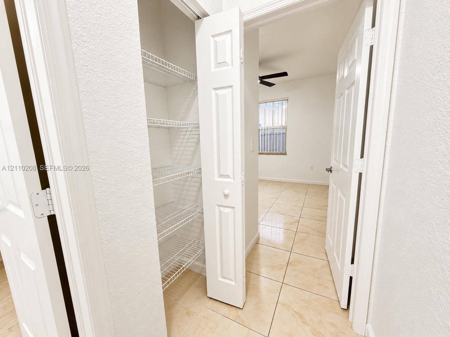 657 SE 30th Terrace, #A, Homestead, Homestead, FL 33033 Built-in storage closet with multi-tier wire shelving, finished with ceramic tile flooring and white paneled doors