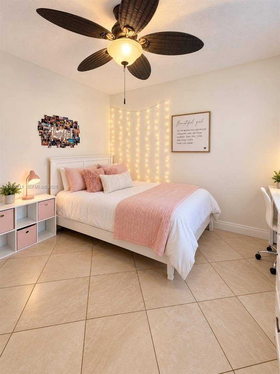Large-format tile flooring paired with a five-blade ceiling fan featuring an integrated light fixture