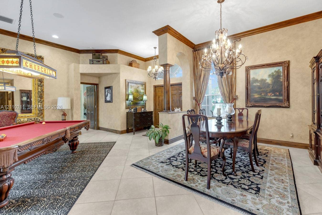 Elegant entertainment spaces featuring a crystal chandelier, formal dining area with wood-finish flooring, and a billiards room with traditional styling