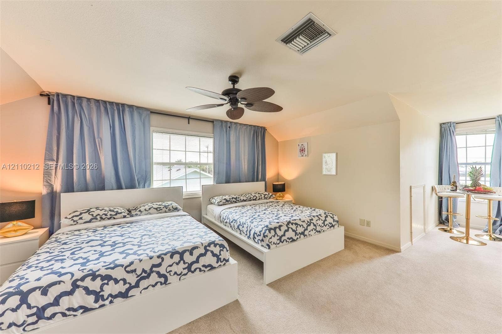 407 SW 37, Cape Coral, FL 33914 Vaulted ceiling featuring a central multi-blade ceiling fan and wall-to-wall carpeting