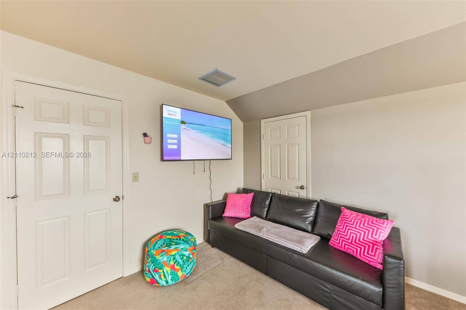 407 SW 37, Cape Coral, FL 33914 Room featuring a neutral wall palette, two solid-core interior doors, wall-to-wall carpeting, and an angled ceiling