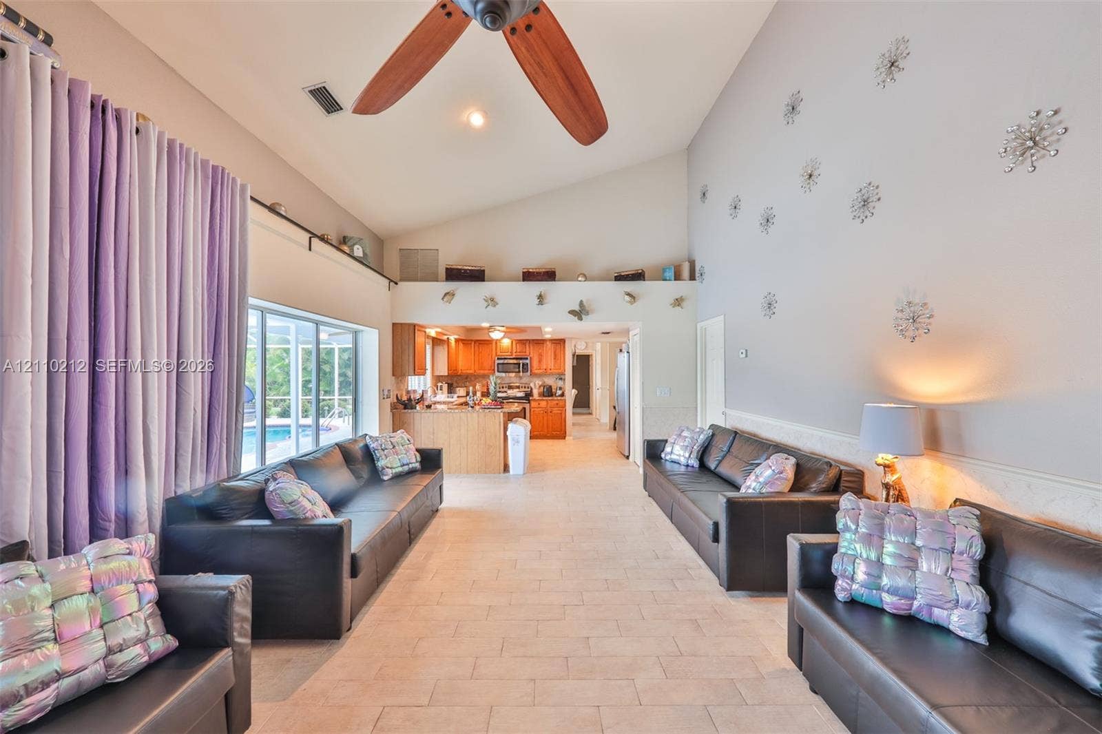 407 SW 37, Cape Coral, FL 33914 Vaulted ceilings, tile flooring, and a ceiling fan with wooden blades
