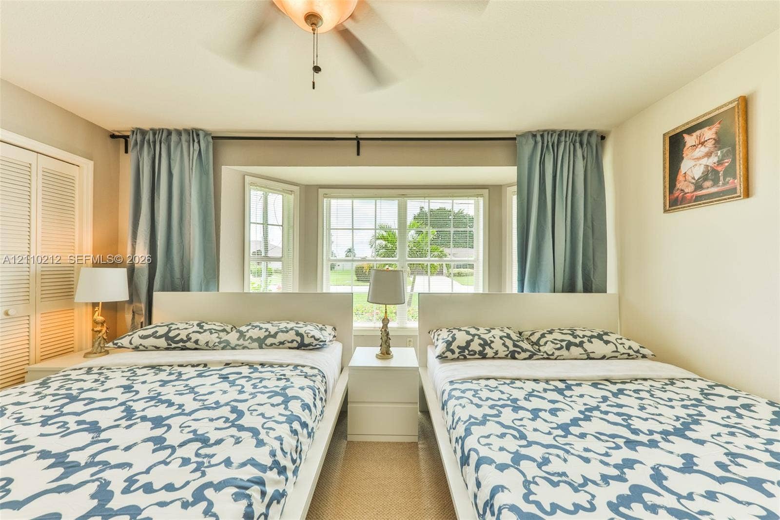 407 SW 37, Cape Coral, FL 33914 Bay window featuring grid-pane glass, louvered bi-fold closet doors, and a ceiling-mounted light fixture