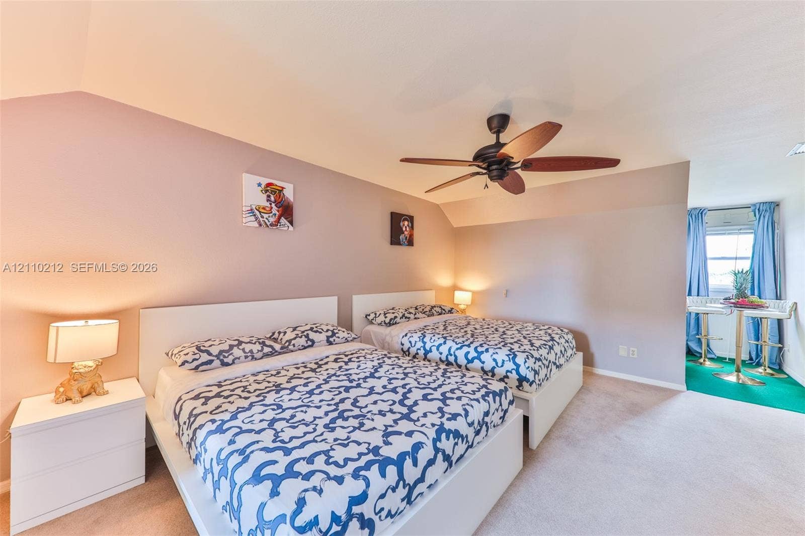 407 SW 37, Cape Coral, FL 33914 Vaulted ceiling with a central multi-blade ceiling fan and wall-to-wall carpeting