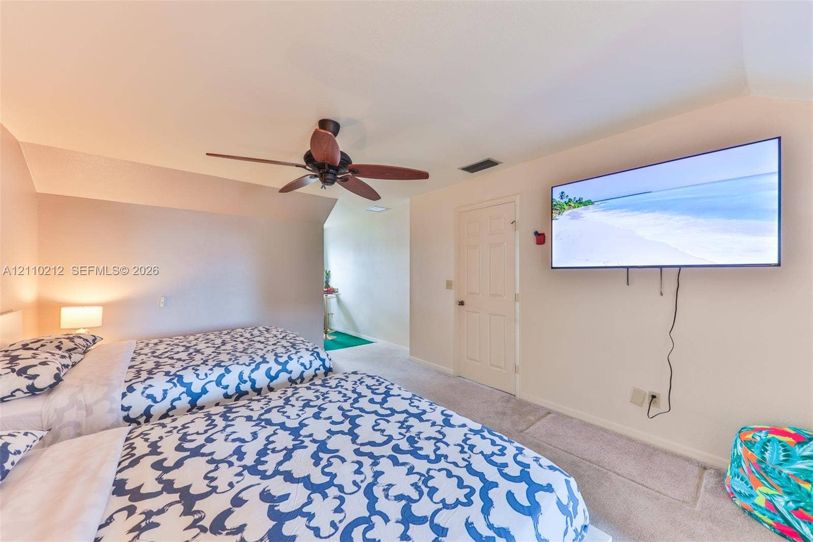 407 SW 37, Cape Coral, FL 33914 Interior space featuring vaulted ceilings, neutral-toned wall paint, wall-to-wall carpeting, a ceiling fan with integrated lighting, and a six-panel interior door