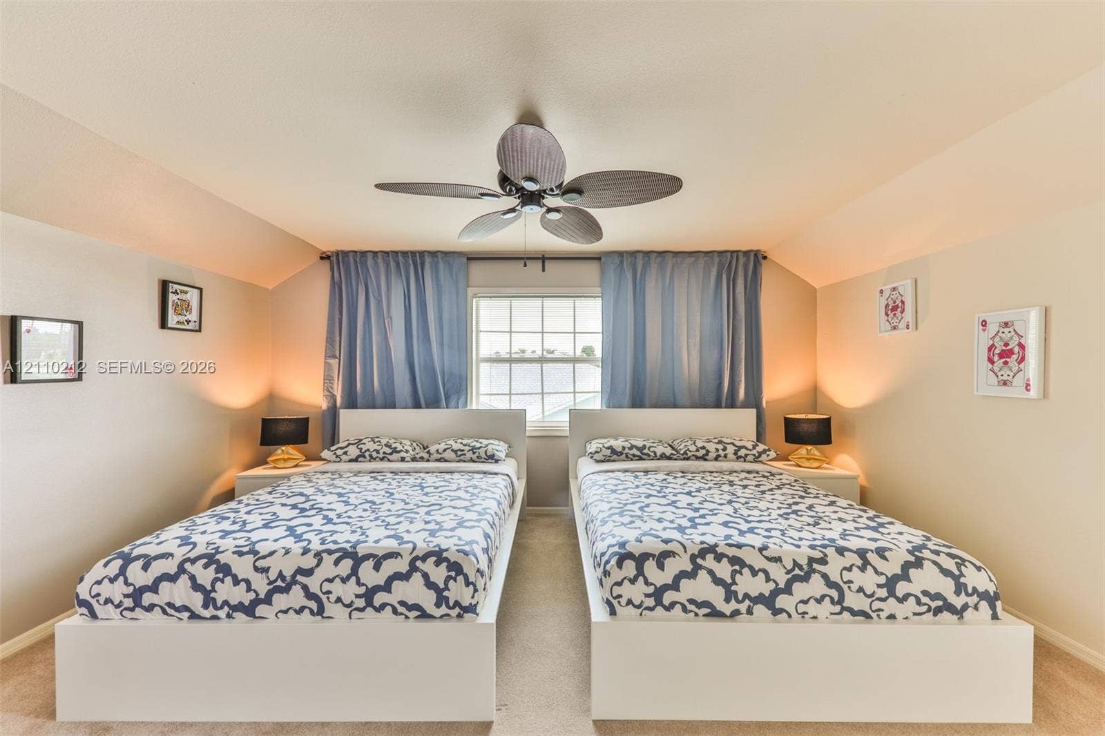 407 SW 37, Cape Coral, FL 33914 Vaulted ceiling featuring a central multi-blade ceiling fan and a single window with exterior light filtration